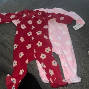 Two onesies the maroon is used the snowflake one is new.
